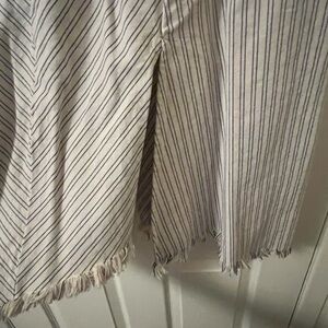 Cream with black pin stripes skirt. It has two splits. One in front and back.